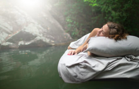 Serene woman sleeping peacefully outdoors on a mattress in nature, emphasizing comfort and restful sleep, ideal for keywords like sleep environment, outdoor relaxation, and healthy sleep.